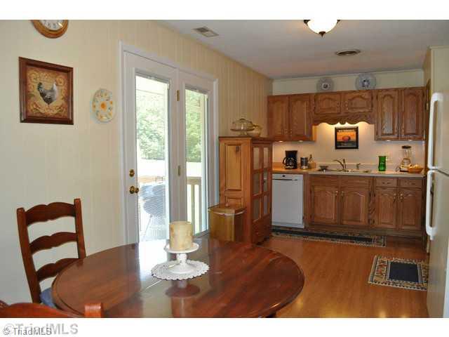 8704 Sweetmeadow Road Colfax, NC 27235 - Photo 5 of 16 Kitchen. Kitchen is large enough for breakfast table. Kitchen & breakfast area have laminate flooring.