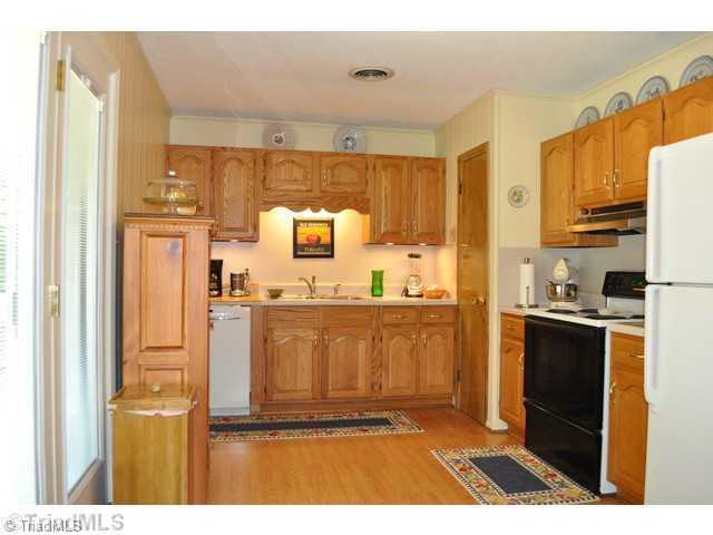 8704 Sweetmeadow Road Colfax, NC 27235 - Photo 6 of 16 Kitchen. Kitchen opens to back deck, convenient for those summer cook outs!