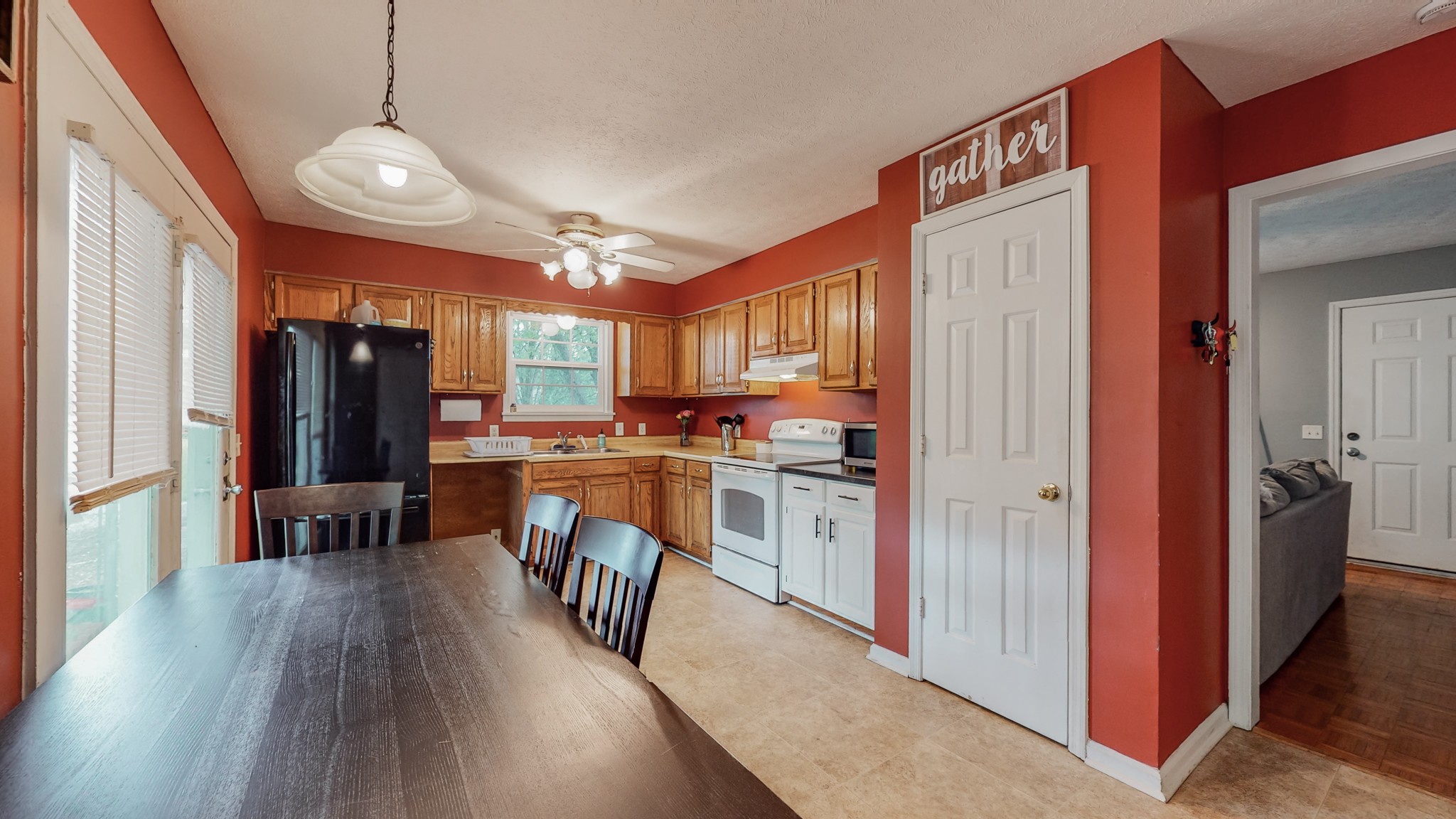 140 Roberts Road Portland, TN 37148 - Photo 21 of 41 a kitchen with stainless steel appliances granite countertop a refrigerator a sink dishwasher a stove and a dining table with wooden floor