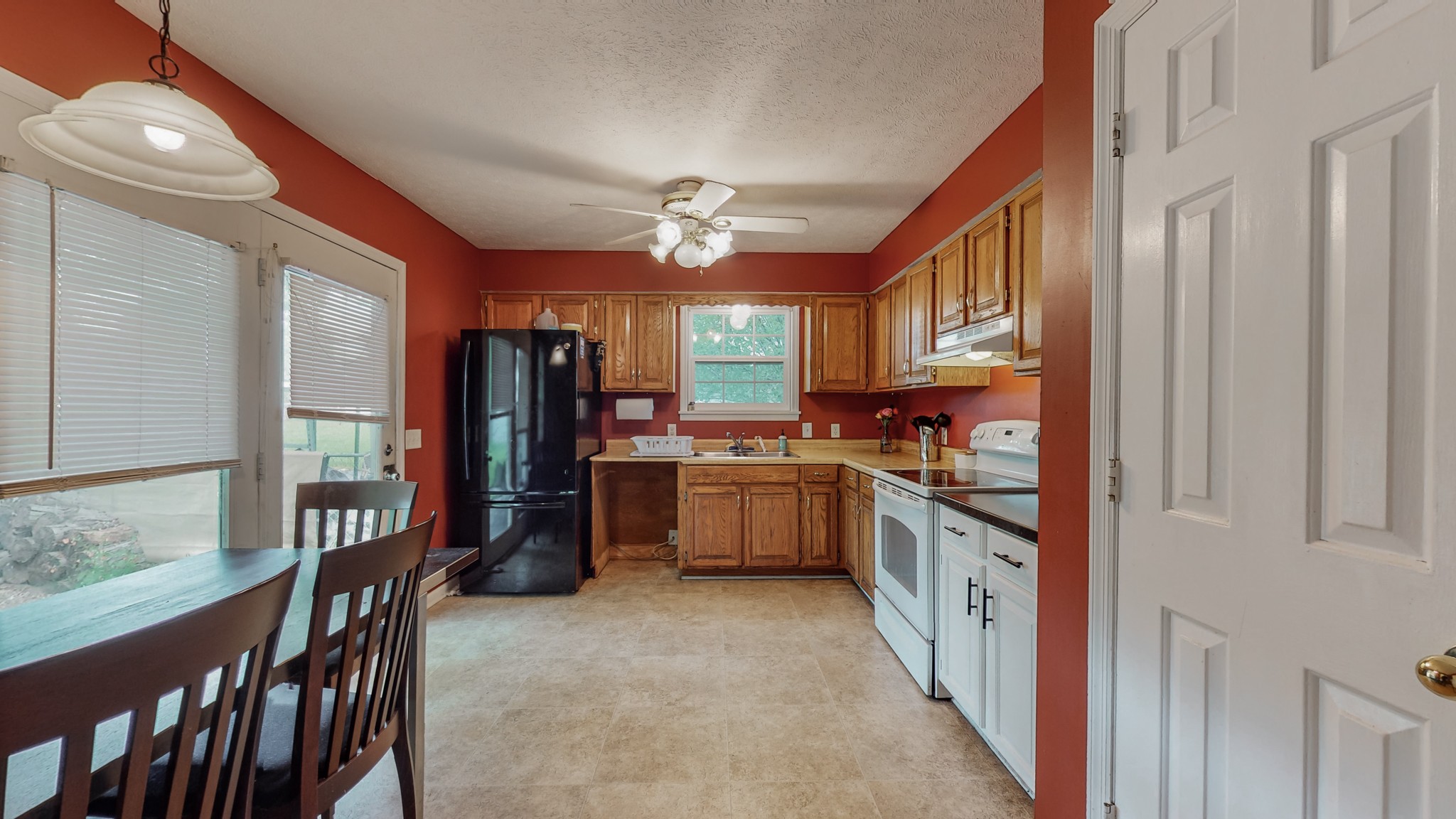 140 Roberts Road Portland, TN 37148 - Photo 24 of 41 a kitchen with stainless steel appliances granite countertop a refrigerator a sink dishwasher a stove and a dining table with wooden floor