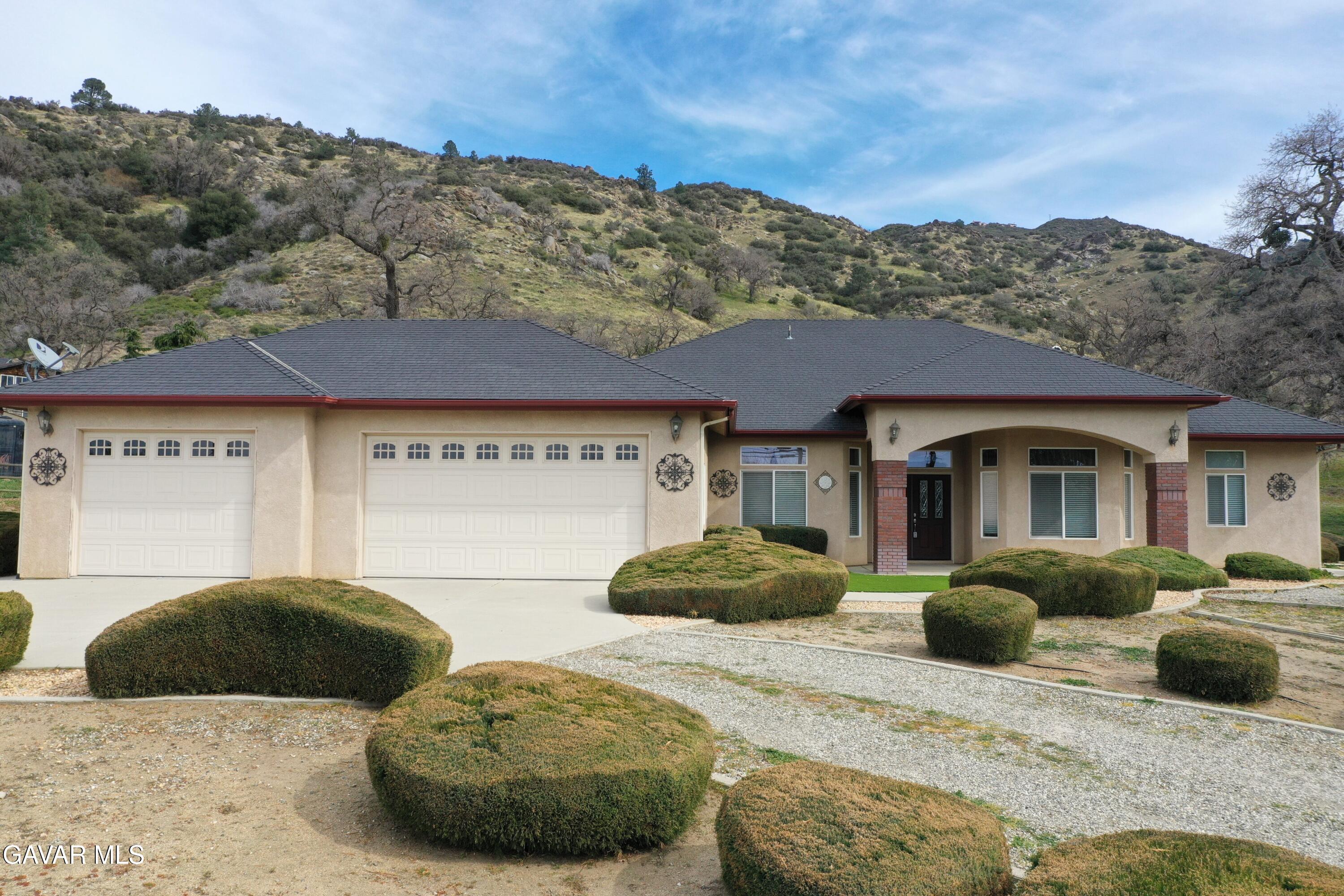 23780 Coyote Court Tehachapi, CA 93561 - Photo 1 of 48 a front view of a house with a yard and potted plants