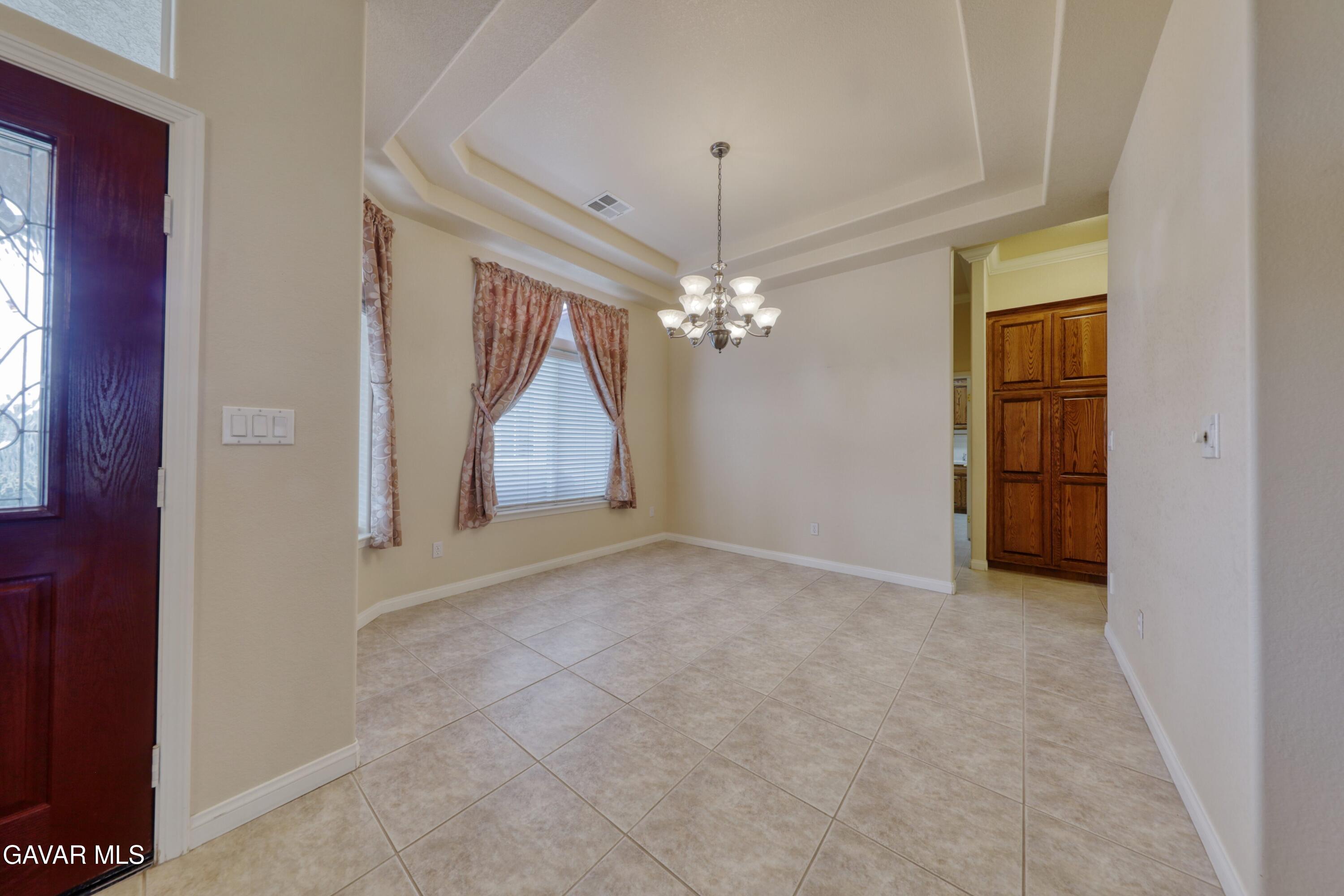 23780 Coyote Court Tehachapi, CA 93561 - Photo 14 of 48 a view of a chandelier in big room and a mirror