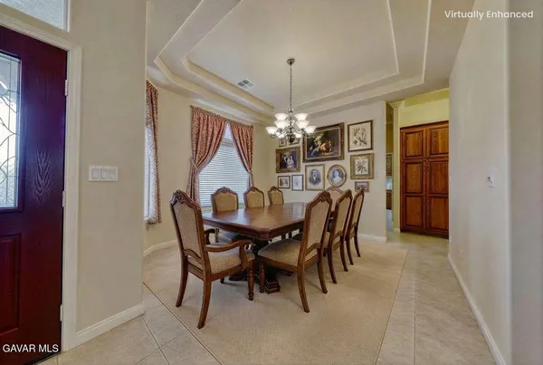 a spacious bedroom with a bed a couch and a chandelier