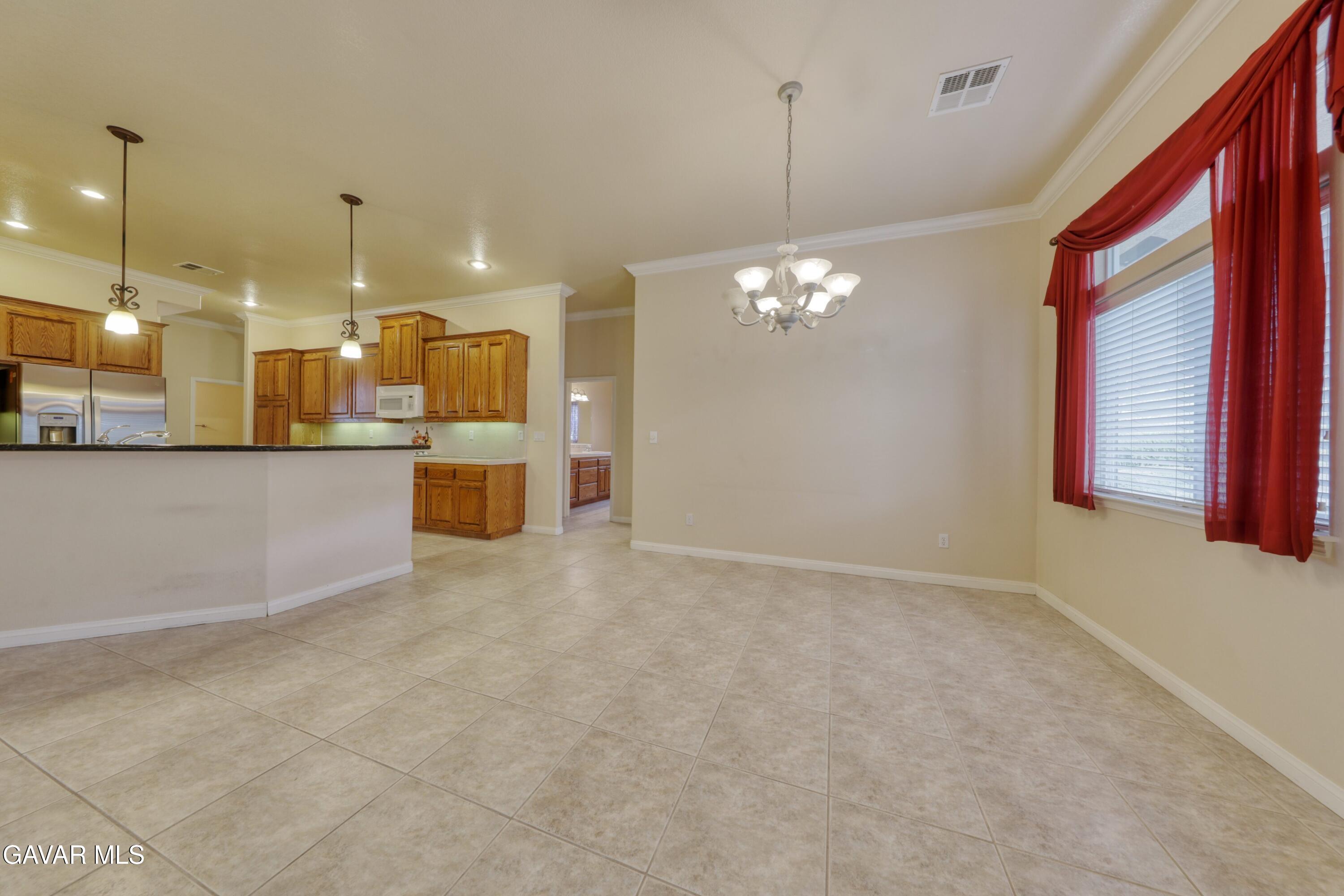23780 Coyote Court Tehachapi, CA 93561 - Photo 19 of 48 a view of a kitchen with granite countertop a large kitchen island in the center