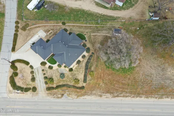 an aerial view of a house with a yard