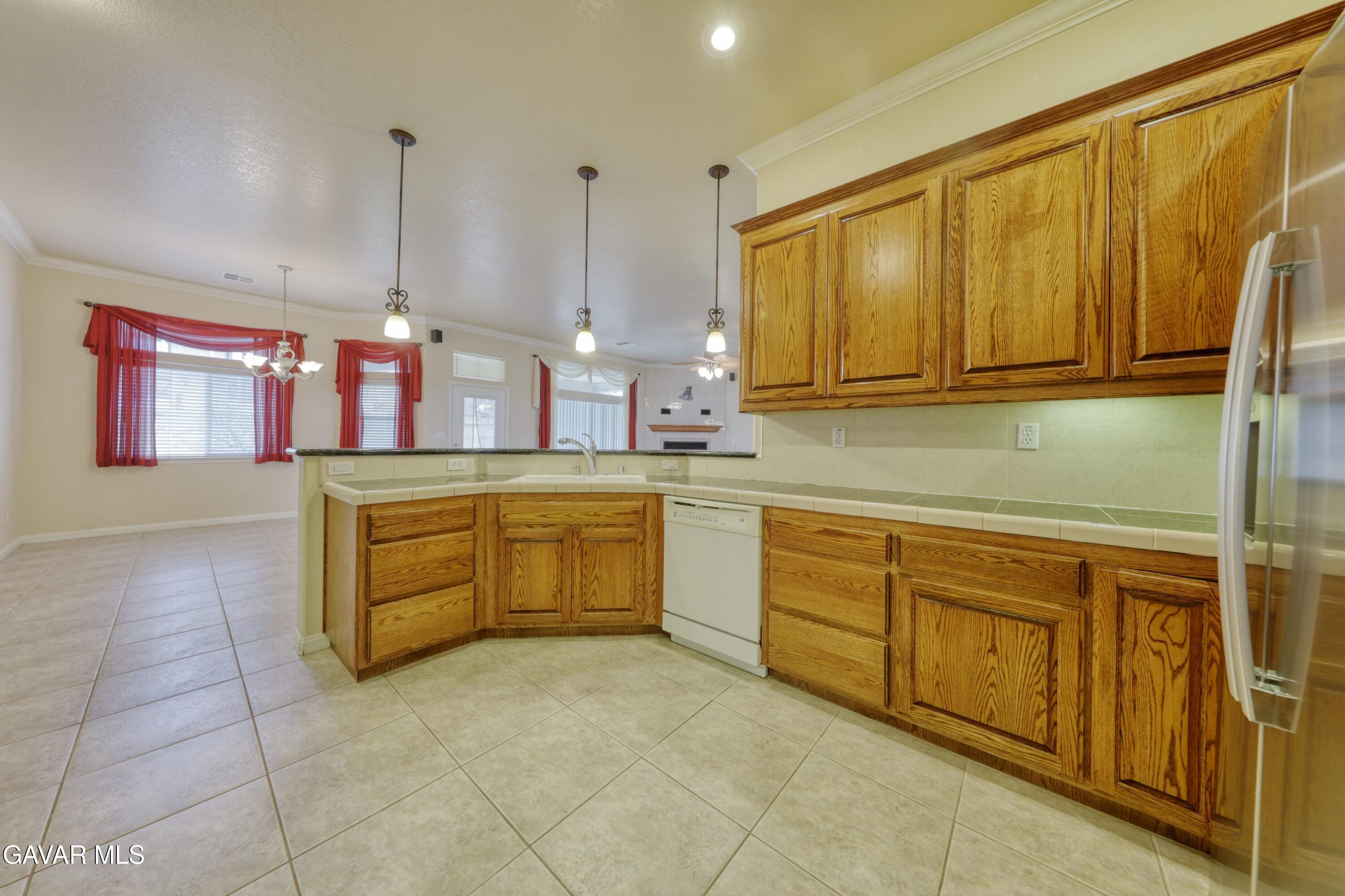 23780 Coyote Court Tehachapi, CA 93561 - Photo 21 of 48 a kitchen with a sink and cabinets