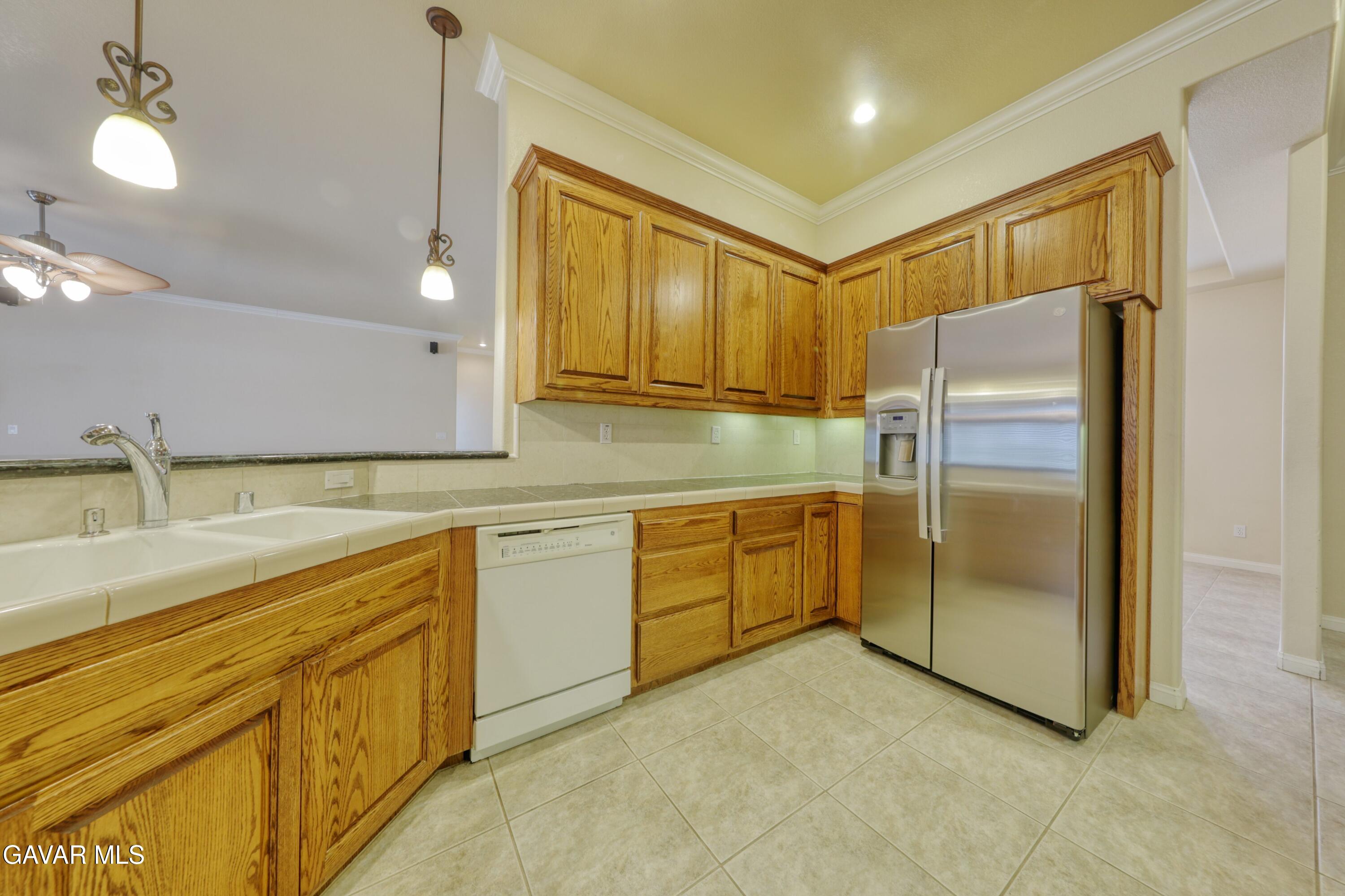 23780 Coyote Court Tehachapi, CA 93561 - Photo 22 of 48 a kitchen with stainless steel appliances granite countertop a refrigerator and a sink