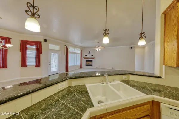 an empty room with a chandelier fan