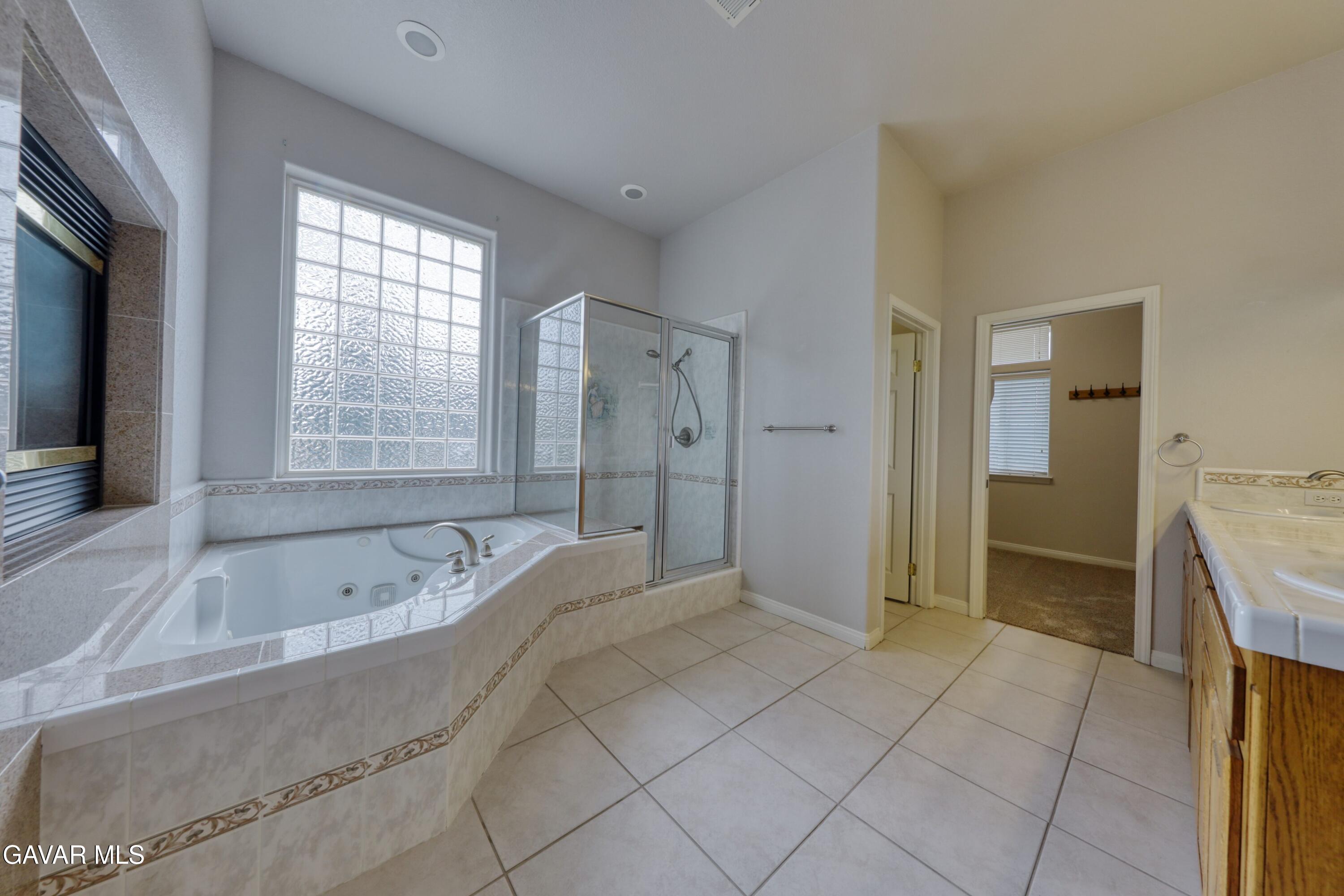 23780 Coyote Court Tehachapi, CA 93561 - Photo 28 of 48 a spacious bathroom with a tub sink and shower
