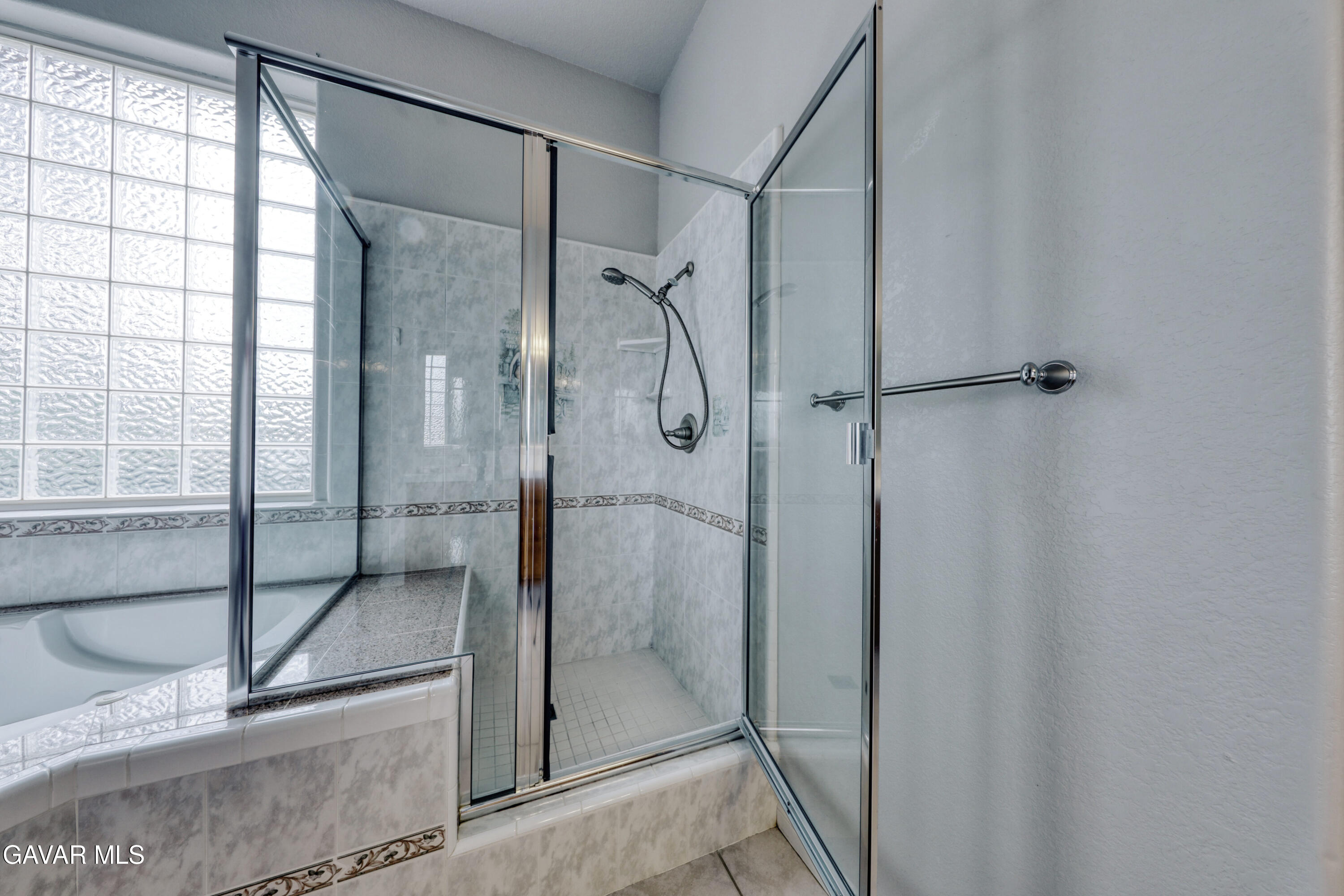 23780 Coyote Court Tehachapi, CA 93561 - Photo 29 of 48 a bathroom with a glass shower door