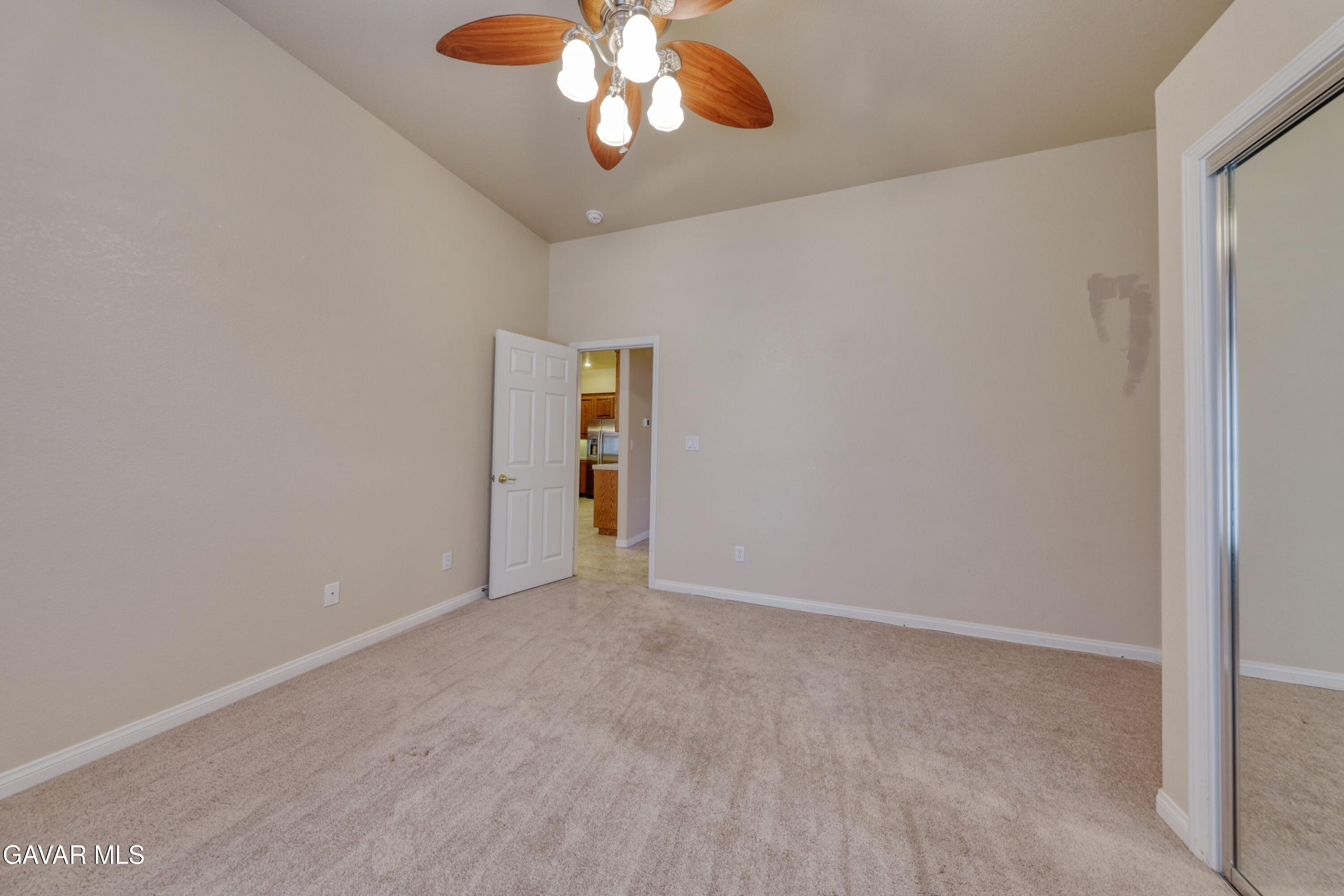 23780 Coyote Court Tehachapi, CA 93561 - Photo 35 of 48 an empty room with a chandelier fan