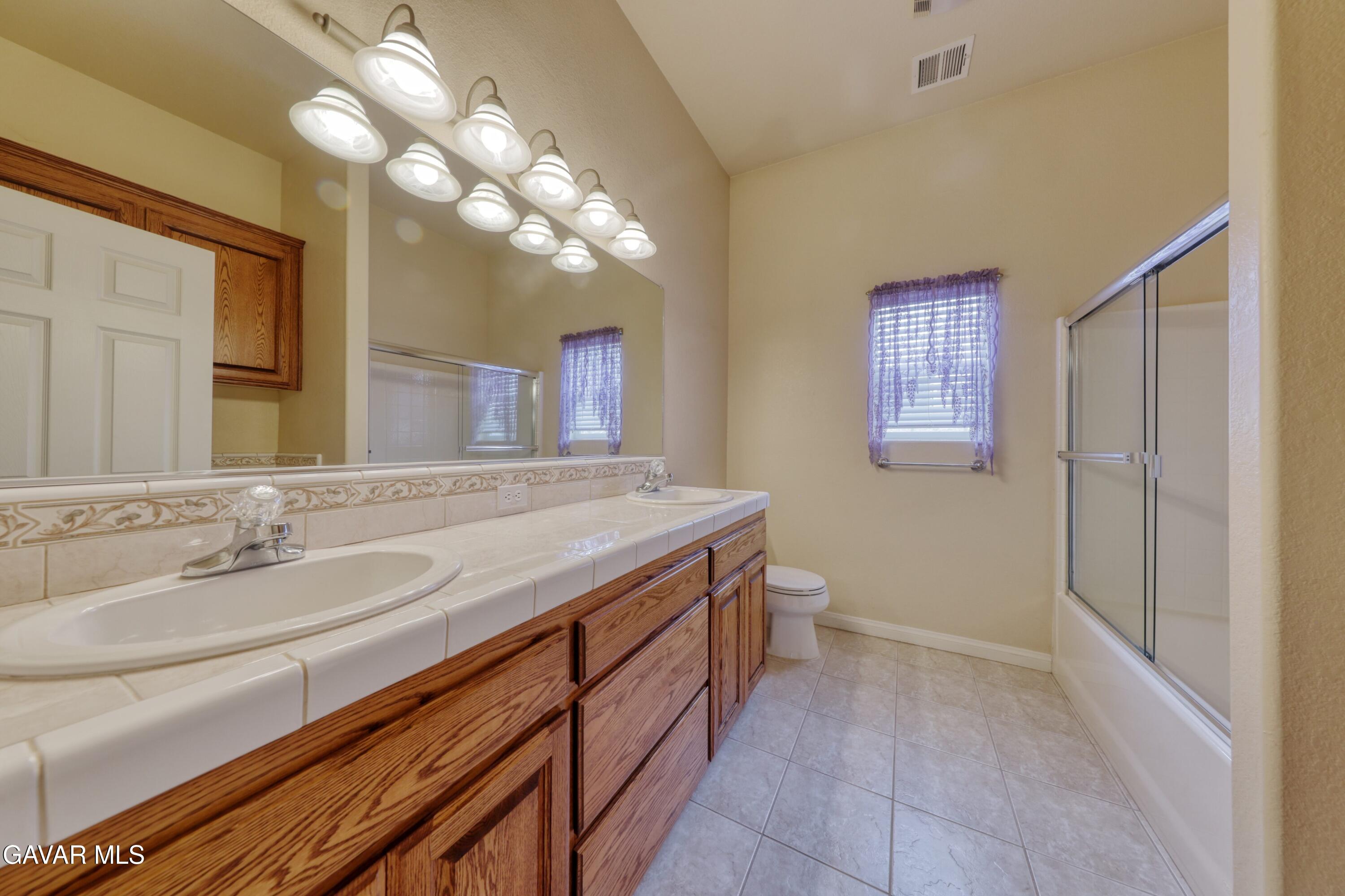 23780 Coyote Court Tehachapi, CA 93561 - Photo 36 of 48 a bathroom with a sink a vanity and a mirror
