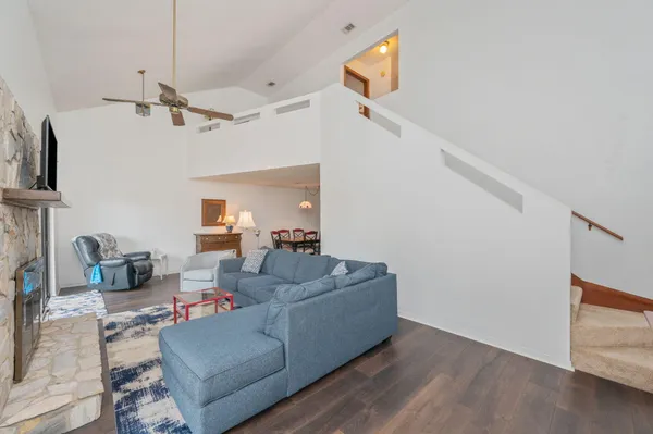 a living room with furniture and a ceiling fan