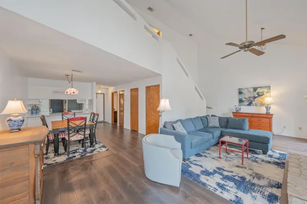 a living room with furniture and a wooden floor