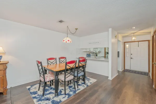 a view of a dining room with furniture and wooden floor