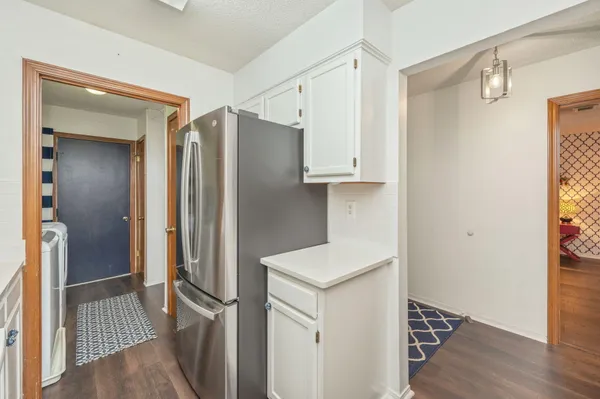 a kitchen with stainless steel appliances a refrigerator and wooden floor