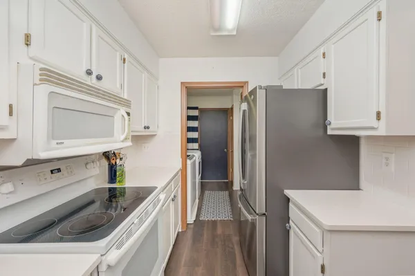 a kitchen with stainless steel appliances white cabinets and a sink