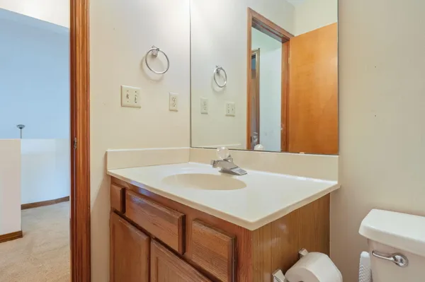 a bathroom with a sink a toilet and a mirror