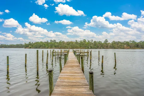 a view of a lake with tables and chairs
