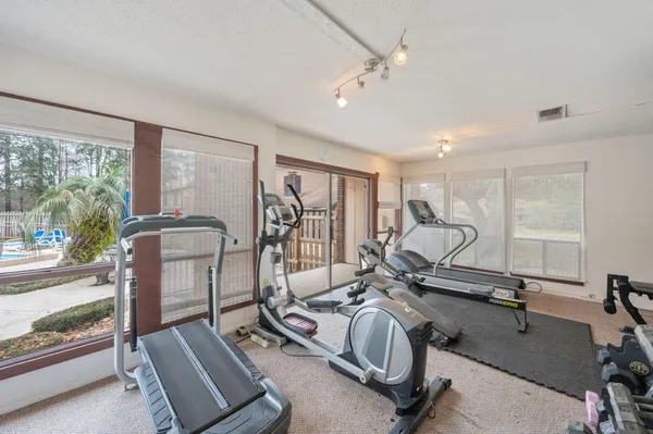 a room with gym equipment and large mirror