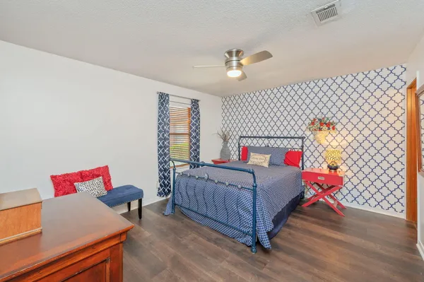 a bedroom with furniture and a wooden floor
