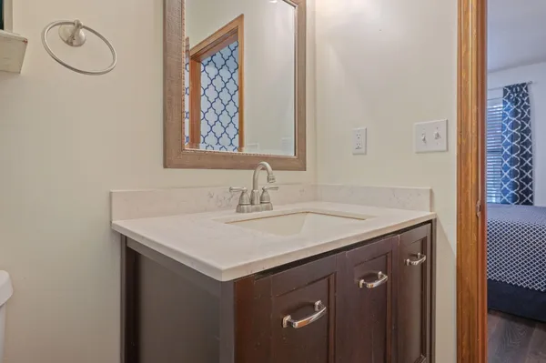 a bathroom with a sink vanity and a mirror