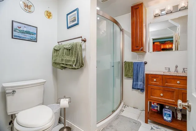 a bathroom with a toilet a sink and mirror