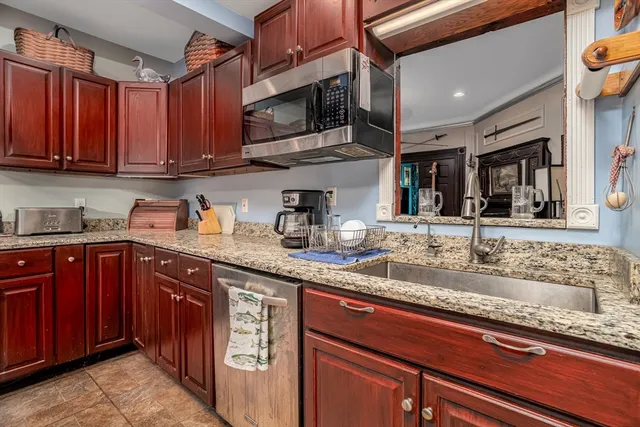 a kitchen with stainless steel appliances granite countertop a sink stove and microwave