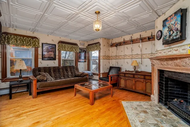 a living room with furniture a fireplace and a table