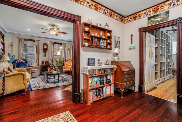 a living room with furniture and a book shelf