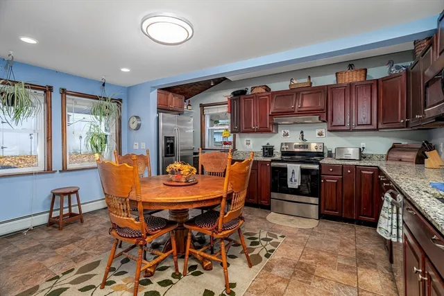 a view of a dining room with furniture a kitchen and chandelier