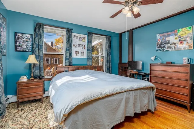 a bedroom with a bed and a dresser in it