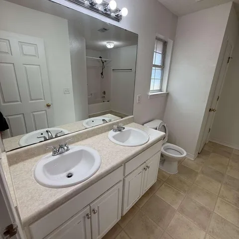 a bathroom with a sink double vanity and a mirror