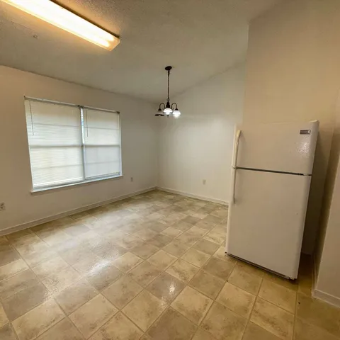 an empty room with windows and entrance