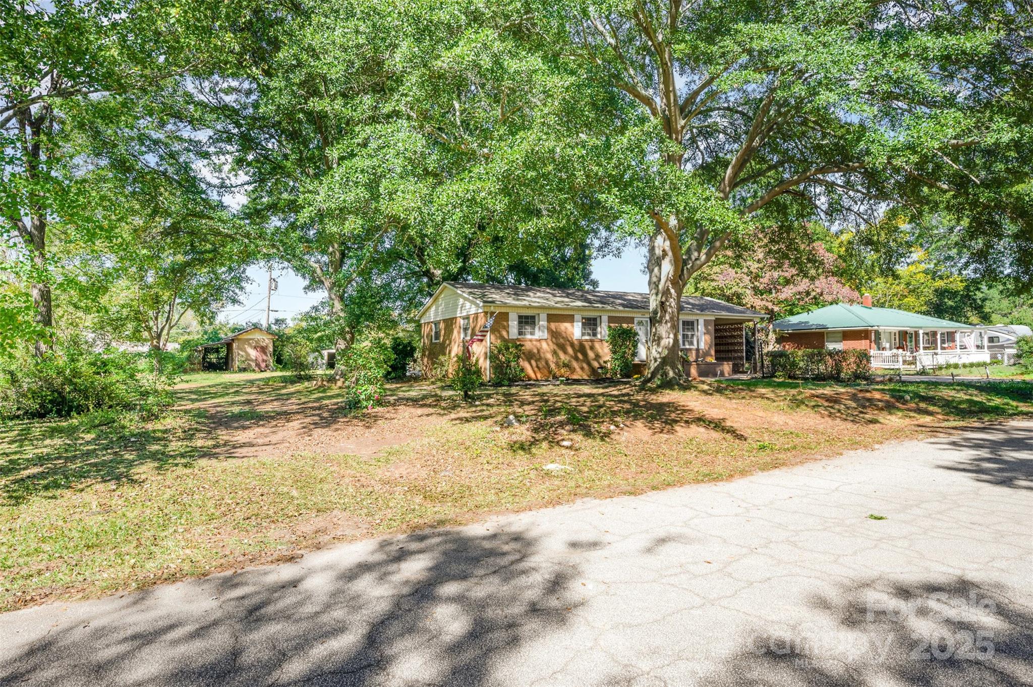 1324 Jefferson Street Lancaster, SC 29720 - Photo 2 of 16 a view of a yard with plants and large trees