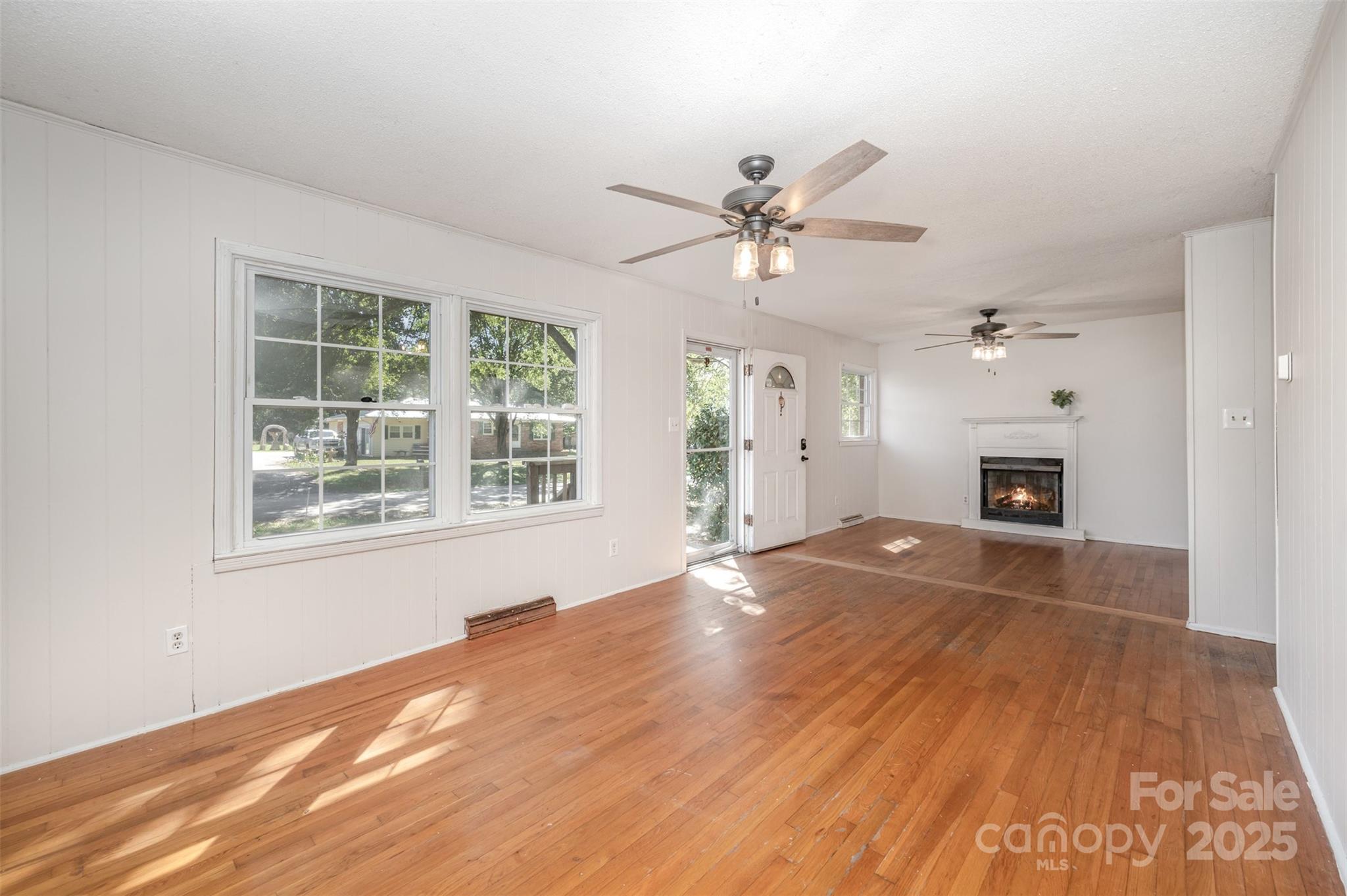 1324 Jefferson Street Lancaster, SC 29720 - Photo 6 of 16 a view of an empty room with a fireplace and a window