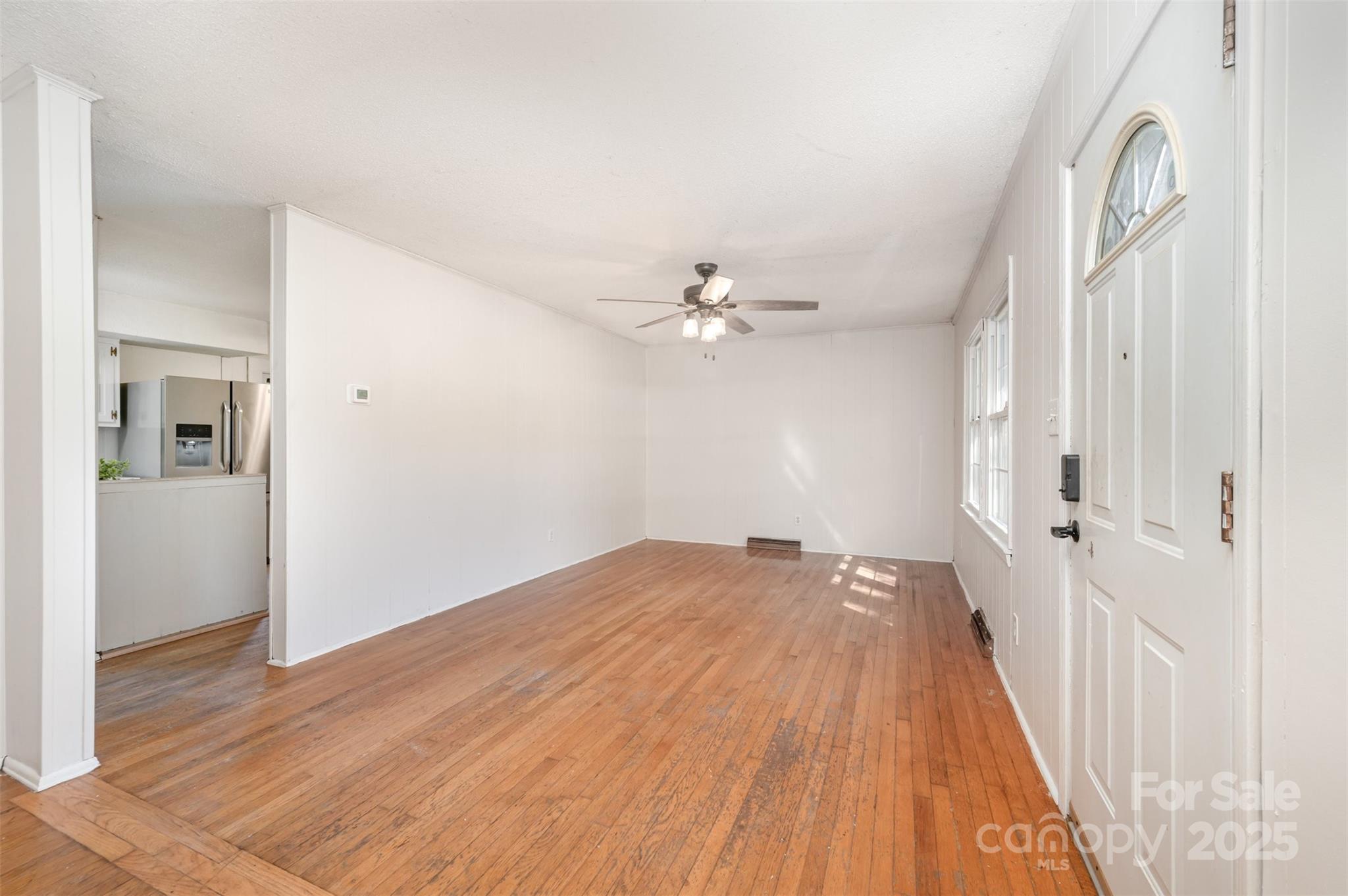 1324 Jefferson Street Lancaster, SC 29720 - Photo 7 of 16 a view of a livingroom with wooden floor and a ceiling fan