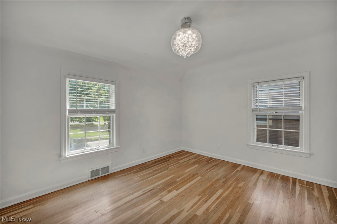3543 Lytle Road Shaker Heights, OH 44122 - Photo 29 of 49 Bright interior room featuring wood-finish flooring, white walls, and a contemporary crystal ceiling fixture