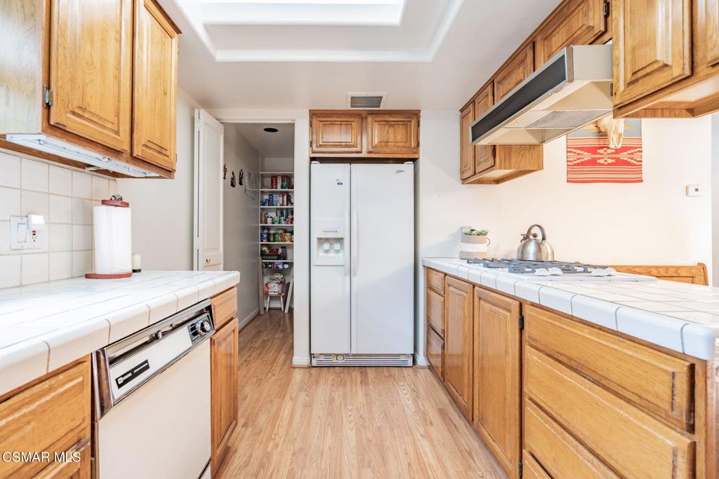 6078 Peppertree Lane Simi Valley, CA 93063 - Photo 19 of 59 a kitchen with stainless steel appliances granite countertop a refrigerator and a sink