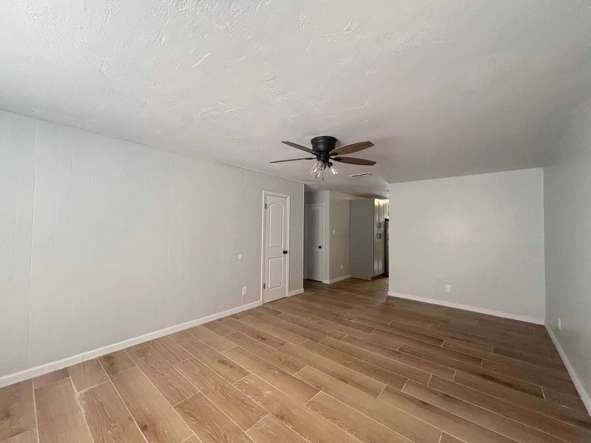 2409 45th Street, Unit 1 Lubbock, TX 79412 - Photo 11 of 11 a view of a big room with closet and a ceiling fan