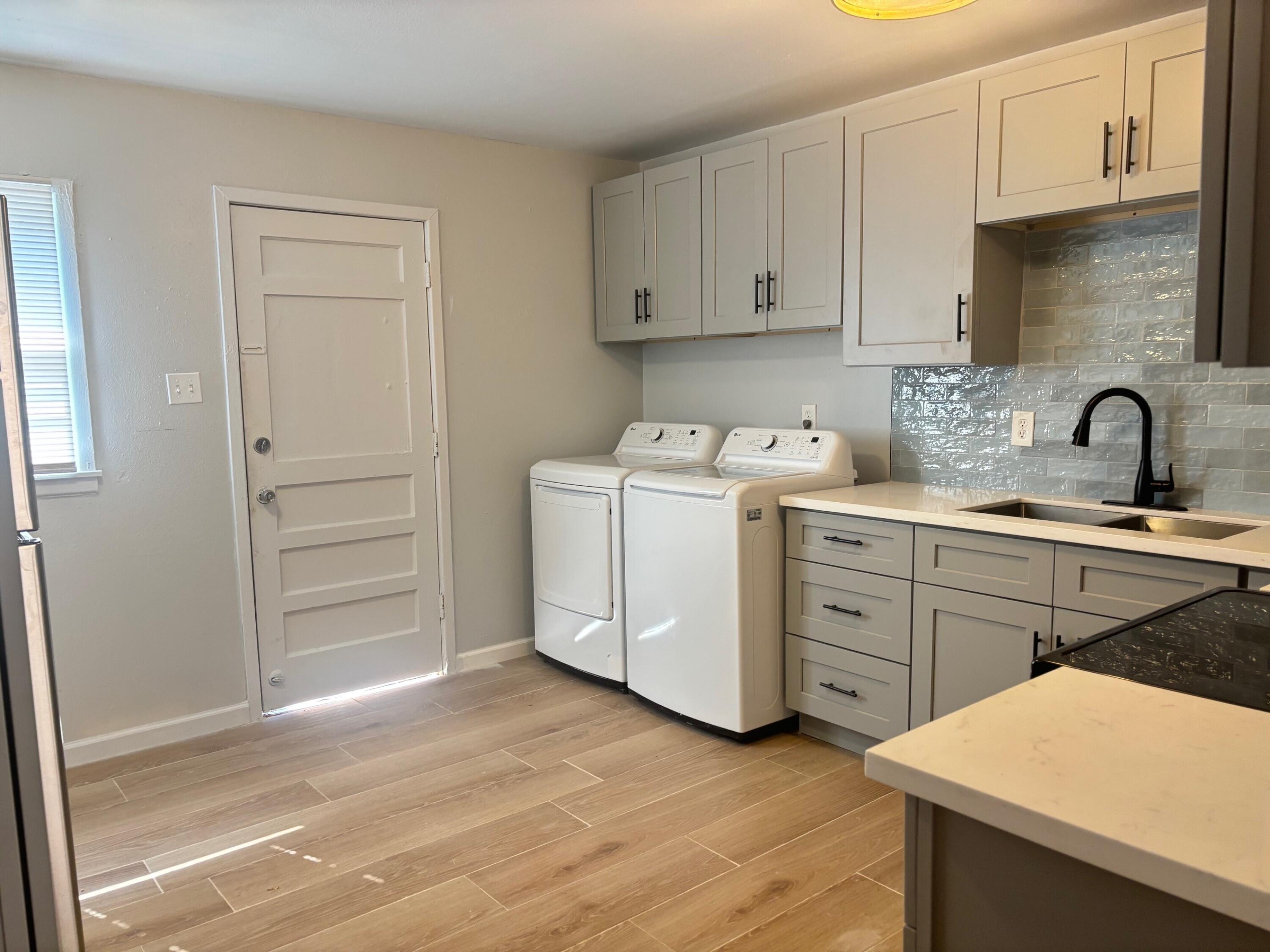 2409 45th Street, Unit 1 Lubbock, TX 79412 - Photo 2 of 11 a kitchen with cabinets appliances and a sink