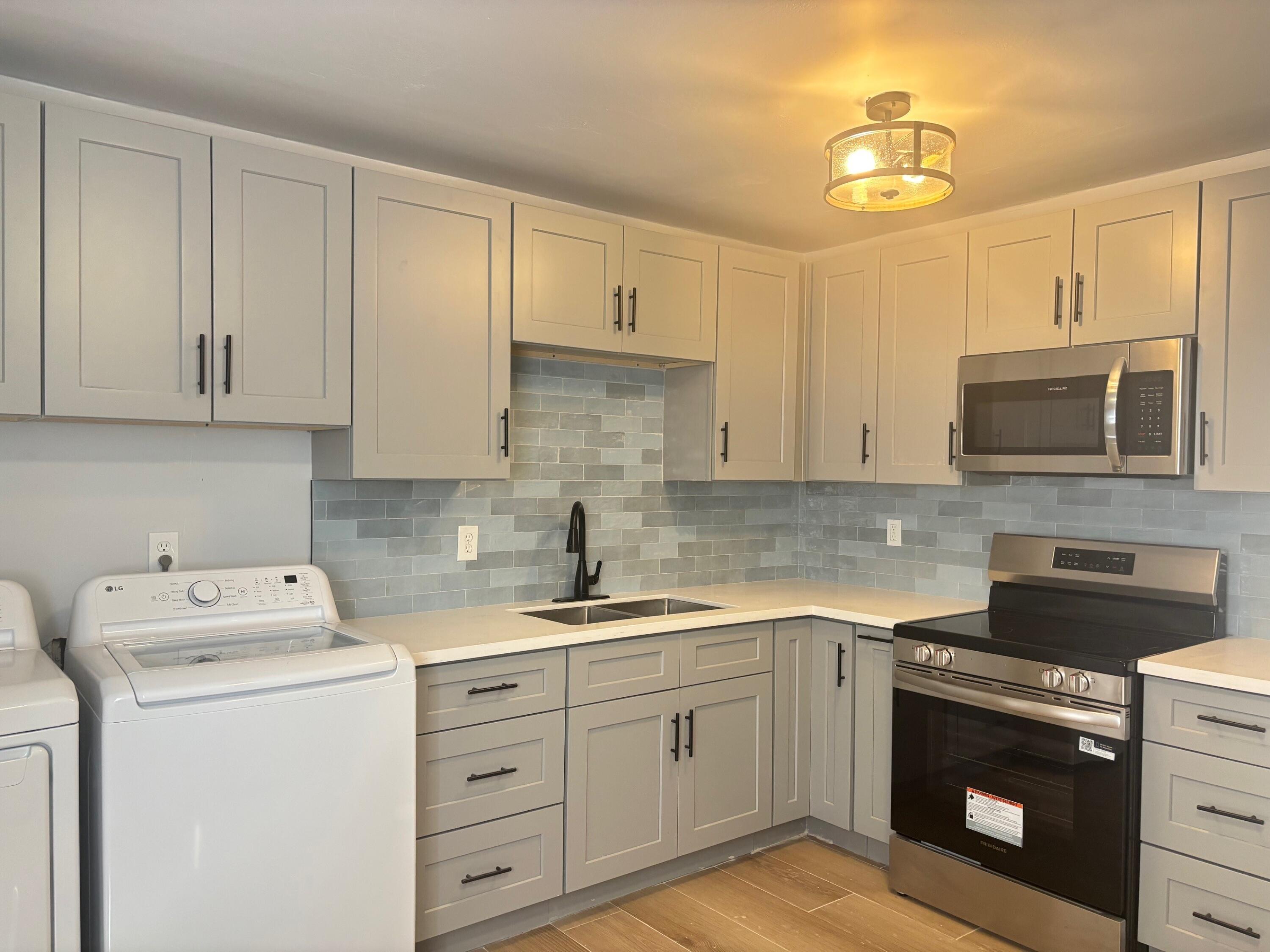 2409 45th Street, Unit 1 Lubbock, TX 79412 - Photo 3 of 11 a kitchen with cabinets stainless steel appliances and a sink