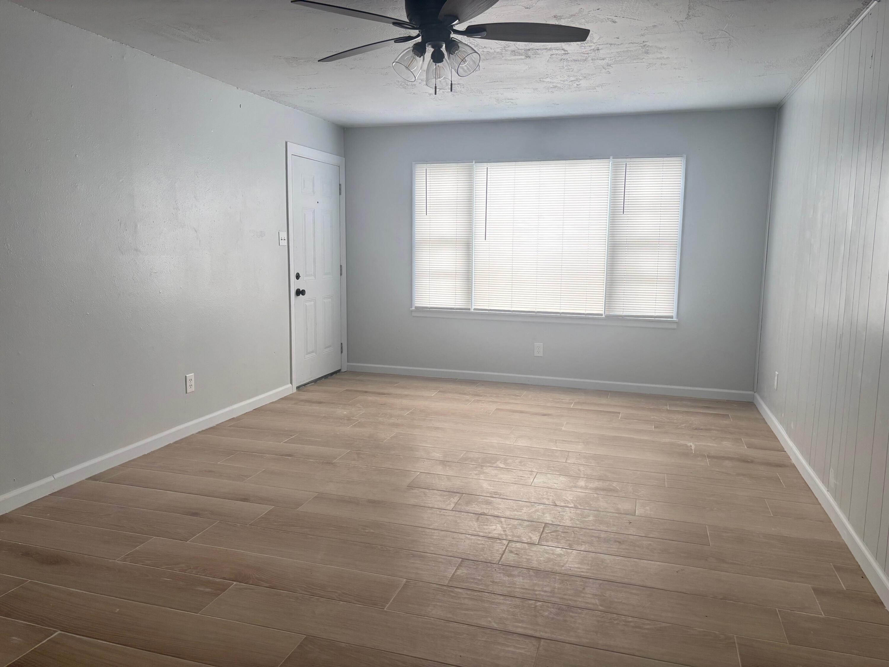 2409 45th Street, Unit 1 Lubbock, TX 79412 - Photo 5 of 11 an empty room with a window