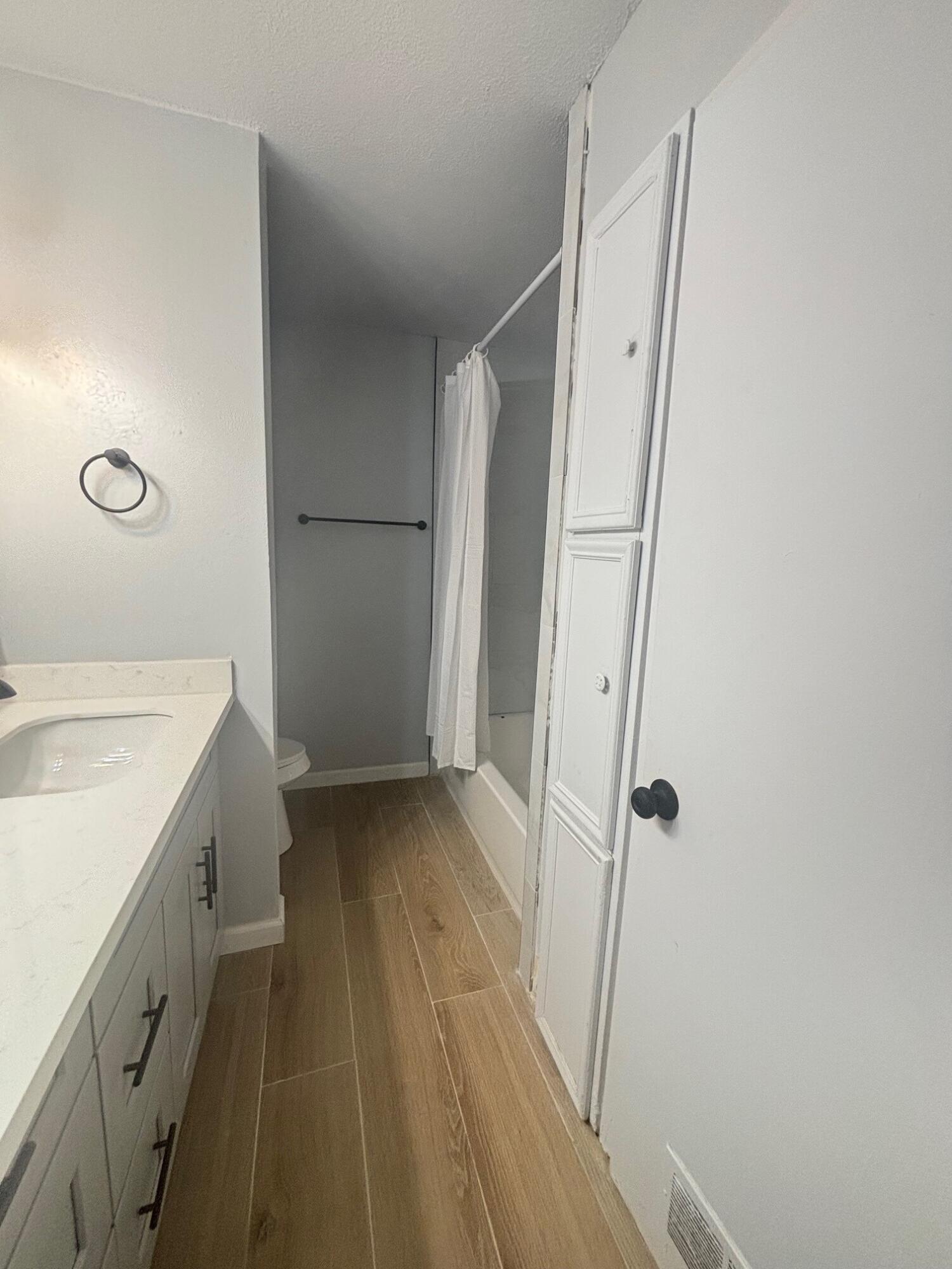 2409 45th Street, Unit 1 Lubbock, TX 79412 - Photo 8 of 11 a bathroom with a sink a toilet and a shower