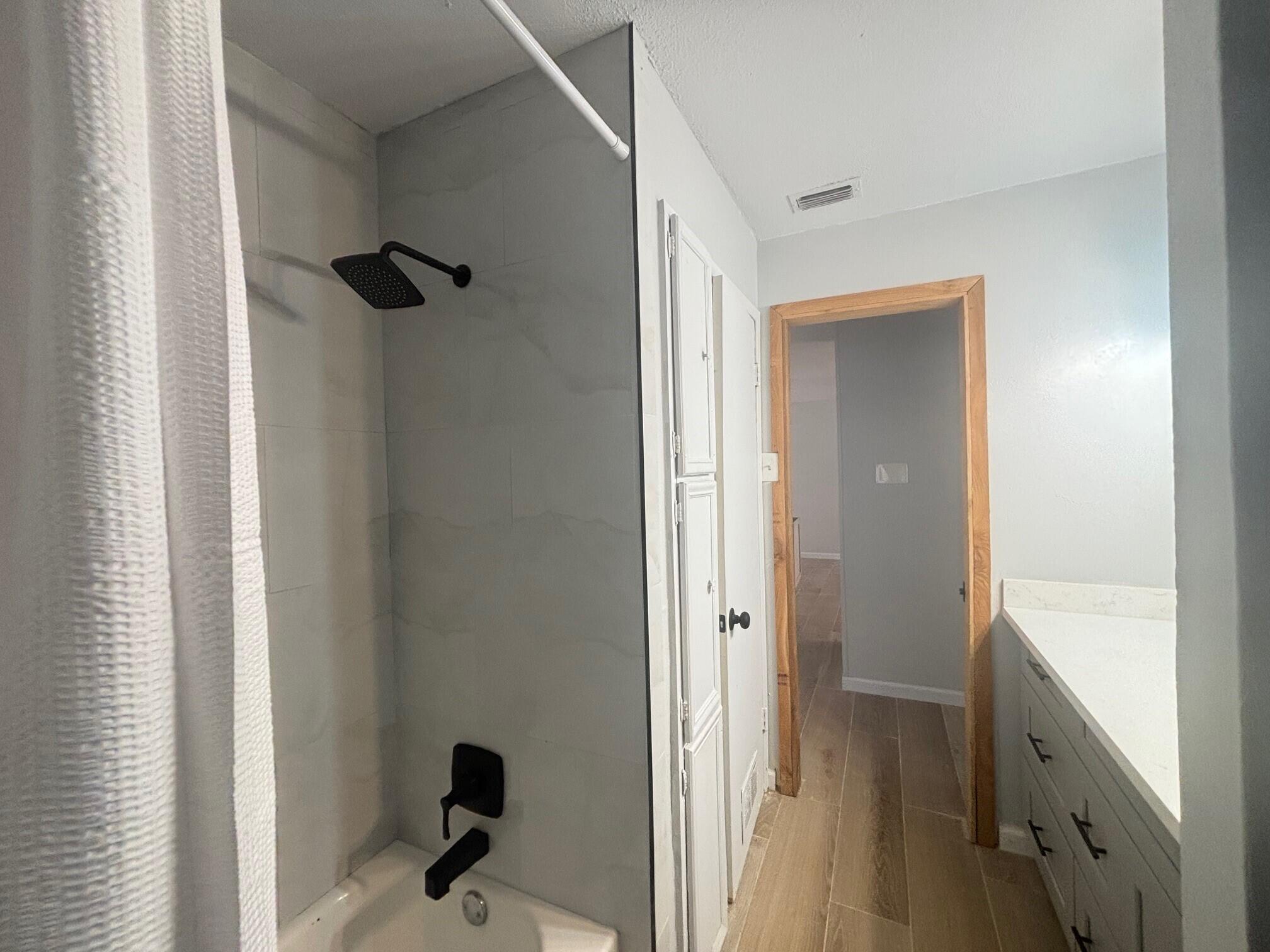 2409 45th Street, Unit 1 Lubbock, TX 79412 - Photo 9 of 11 a bathroom with a sink and a mirror