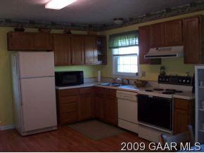 656 Battlefield Road New Hope, VA 24437 - Photo 6 of 12 a kitchen with a refrigerator and a stove top oven