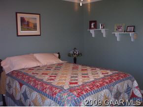656 Battlefield Road New Hope, VA 24437 - Photo 8 of 12 a bed sitting in a bedroom and painting on the wall