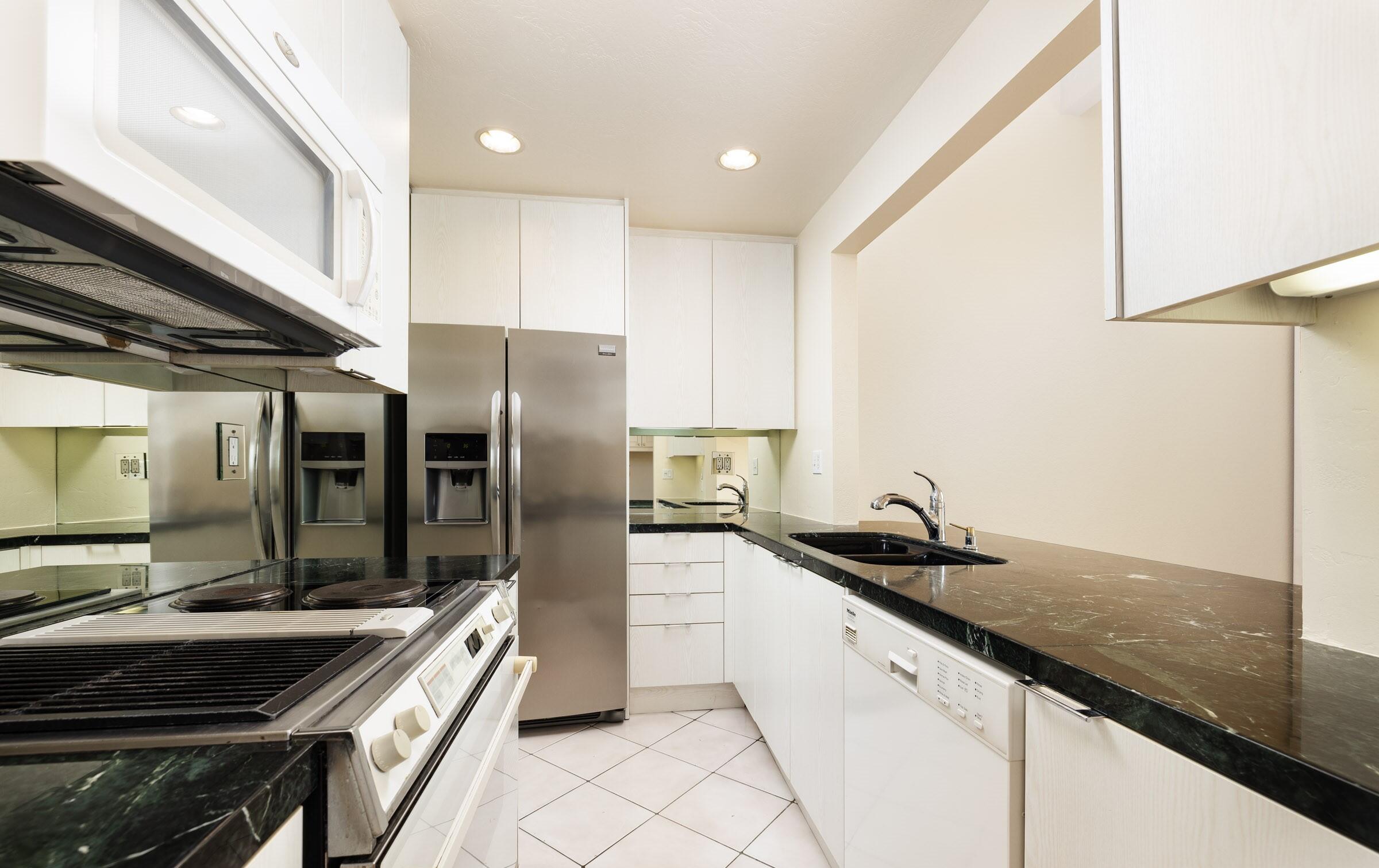 3375 Foothill Road, Unit 632 Carpinteria, CA 93013 - Photo 7 of 16 a kitchen with granite countertop a sink stainless steel appliances and cabinets