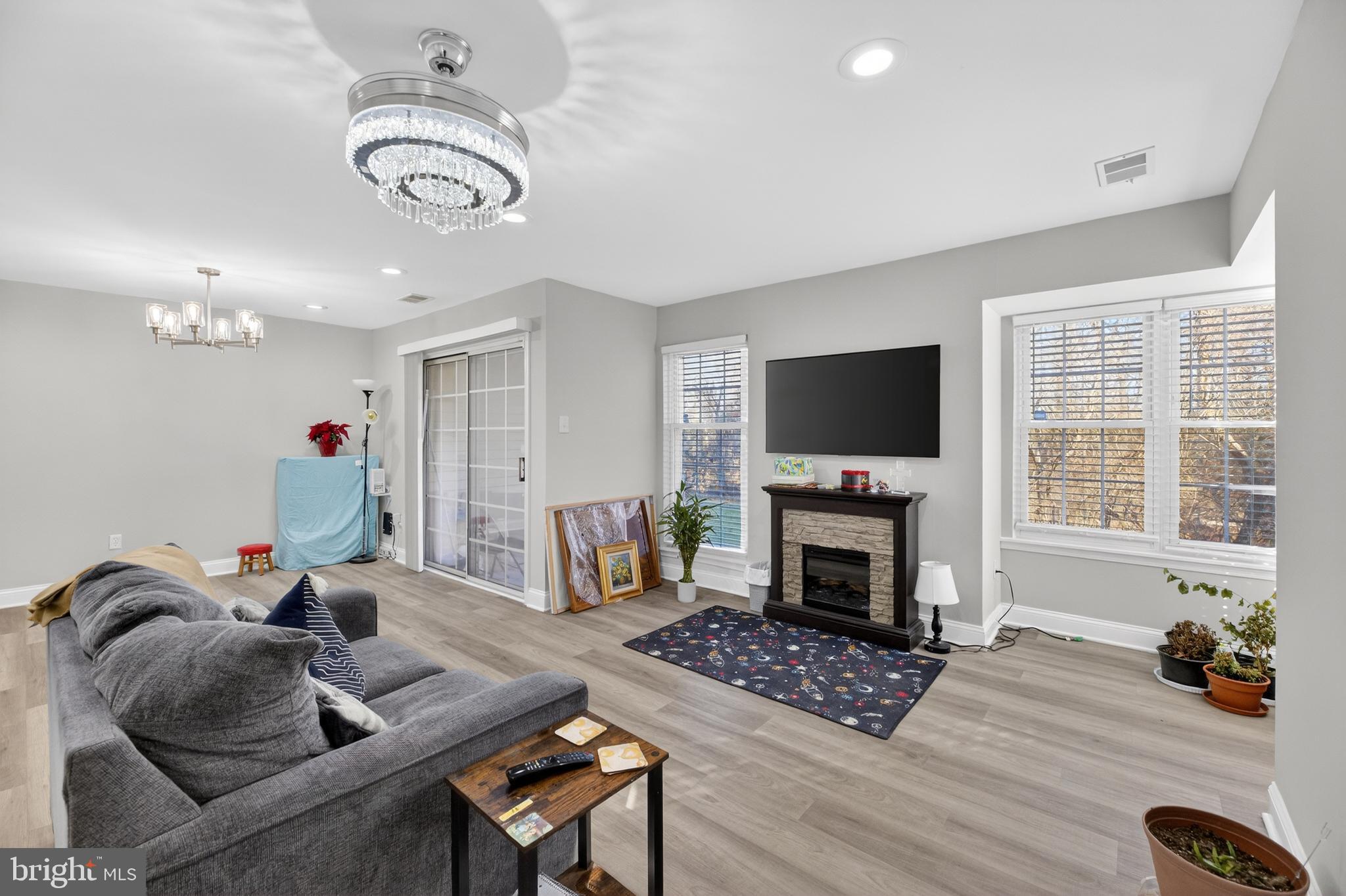 a living room with furniture a flat screen tv and a fireplace