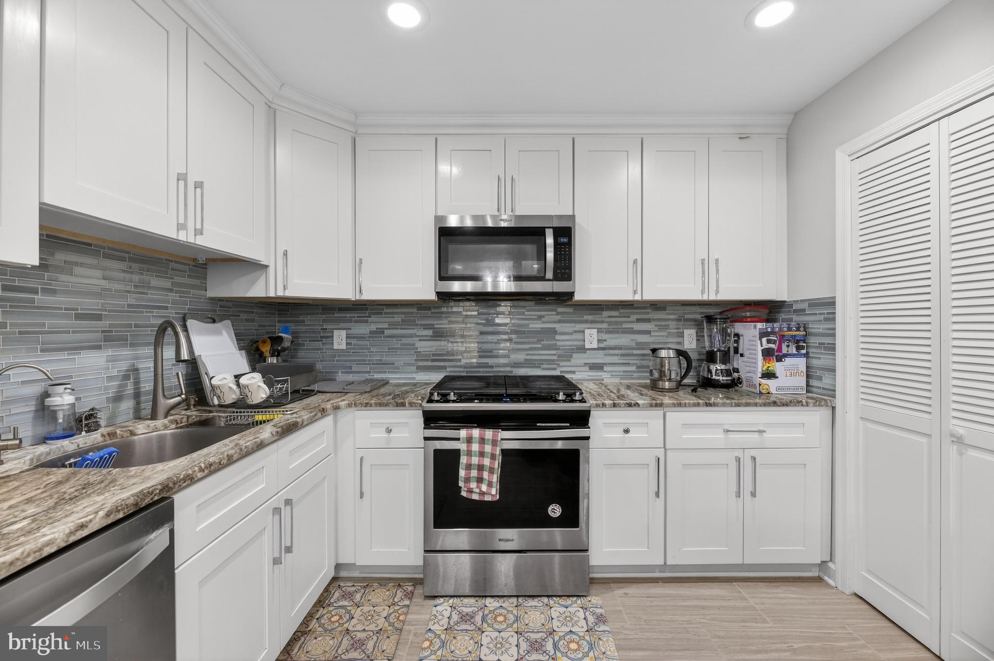 133 Andover Place Robbinsville, NJ 08691 - Photo 11 of 20 a kitchen with white cabinets and appliances